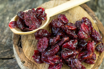 Dry cranberry on wooden background close up