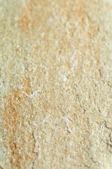 Grainy texture of yellow-beige raw slate with reddish inclusions. Shale and Sandstone, facing with natural stone.