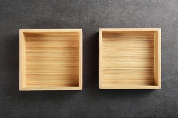 Wooden boxes or trays on the gray texture