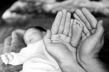 stopa noworodka w dłoniach