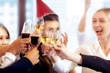 Clinking Glasses of Champagne or Wine. Group of Business People Celebrating New Year at Office party.