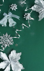Christmas background. Xmas or new year white silver color decorations on green  background with empty copy space for text.  holiday concept for postcard or invitation. top view . flat lay