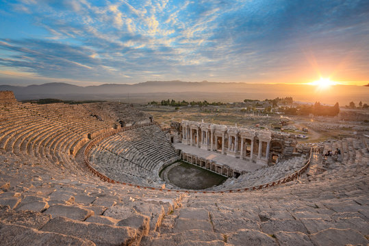 Beautiful sunset view of the Ancient theater of the Roman city of Hierapolis in Pamukkale, Turkey. The site is a UNESCO World Heritage site near the city of Denizli. 