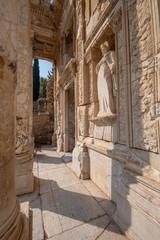Fototapeta premium Library of Celsus and sculpture in the ancient city of Ephesus, Selcuk Izmir, Turkey. The UNESCO World Heritage site was is an ancient Roman building on the coast of Ionia in honour of Tiberius. Efes
