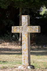 Ancient stone cross graveyard headstone. Religious monument gravestone in cemetery.