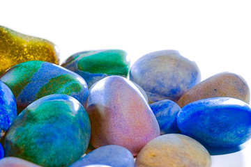 Synthetic nature. Polished colored beach pebbles selective focus close-up.