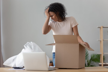 Frustrated black girl disappointed with purchased product