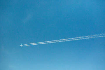 jet plane and contrail against clear blue sky