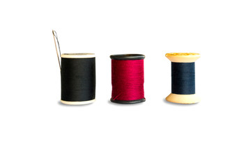 Black,red ,blue thread and needle  isolated on white background
