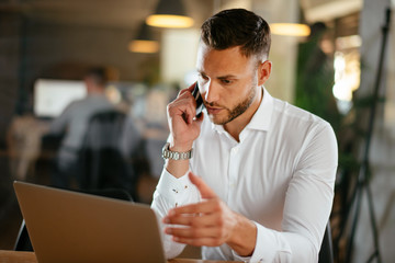 Businessman discussing work on phone