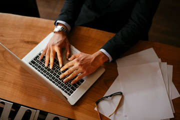 Top view of businessman's hands using laptop