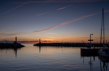 Obraz premium Cala Bona Marina Majorca Sunrise an array of golden colours and dramatic sky reflecting in the calm harbour water.
