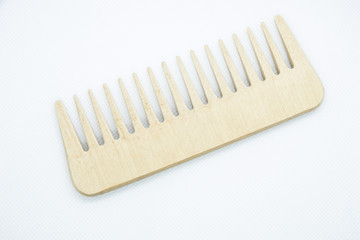 A light brown wooden comb