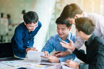 A group of busy business men working on a plan.