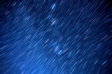 Star trails movement at night.Abstract long exposure of strail trails against a blue sky at dark night.
