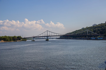 Tour of Kiev in the center of Europe. View of the Dnieper, Trukhanov island and a foot bridge. Park fountain and sunset on the horizon..