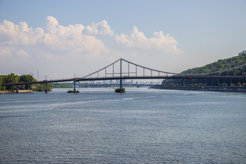 Tour of Kiev in the center of Europe. View of the Dnieper, Trukhanov island and a foot bridge. Park fountain and sunset on the horizon..