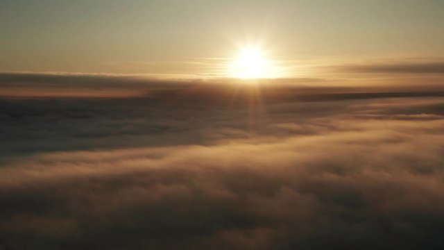 Long slow dramatic cloudscape aerial shot at sunrise
