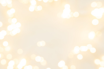 Frame of defocused Christmas lights on white wooden background. Christmas and New Year holidays celebration concept