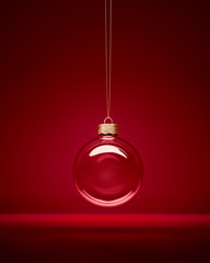 Christmas glass bauble hanging in front of luxury dark red background. Transparent winter...