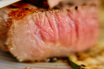 Macro photo with shallow depth of field of section of beef steak medium rare
