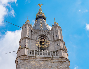 Detail of the top of the Belfry of Ghent on a sunny day. Beautiful architecture and landmark of the medieval city of Gent in Belgium on summer.
