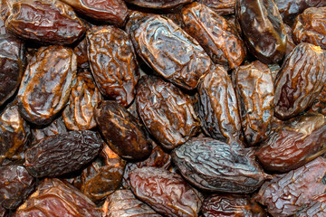 Dried dates background. Fresh arabic dates. Date palm fruit. Top view. Dried date fruit pattern.