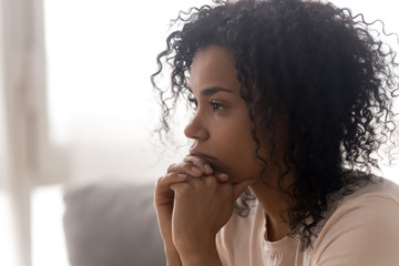 Close up of pensive black woman thinking having life troubles - Powered by Adobe