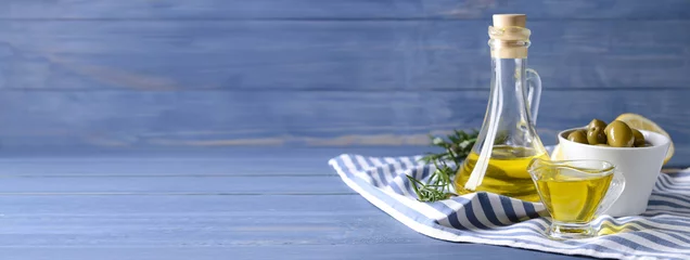 Zelfklevend Fotobehang Tasty olive oil on wooden table with space for text © Pixel-Shot