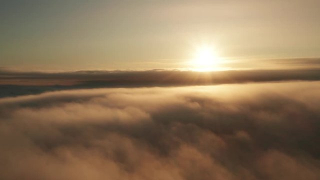 High above clouds elevated aerial time lapse view at sunrise