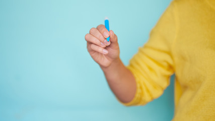 Young woman drawing on turquoise with white blue