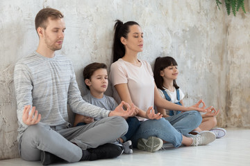 Mindful calm happy healthy family practicing breathing yoga exercises.