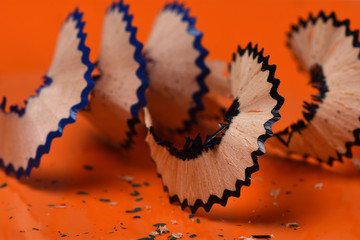 pencil shavings on  orange background close-up - Powered by Adobe