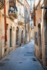 View of an old street in the city centre of Ortigia (part of the city of Siracusa, Italy, Sicily).