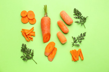 Fresh carrots with pieces on color background