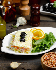 mimosa salad in the plate with orange slices