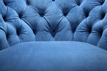 Detail of classical furniture. Velour armchair close-up with part of the seat. Blue velvet with...