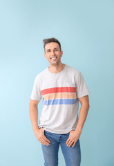 Fototapeta premium Portrait of stylish young man on color background