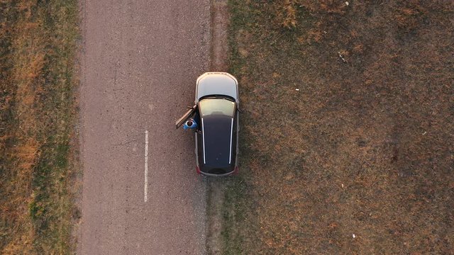 Aerial View Woman Entering Car And Driving Away