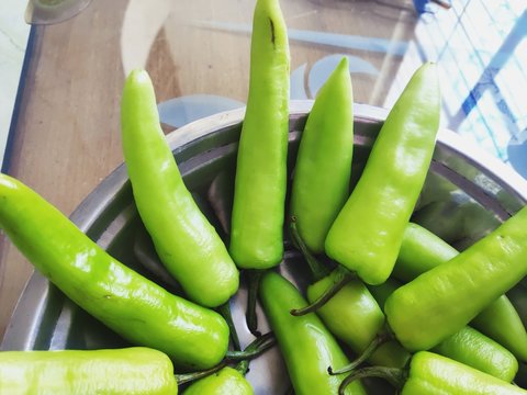 Raw Green Spicy Hatch Peppers In A Steel Bowl. Flower Pattern.