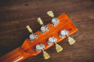 The red guitar that was laid on the floor of an old wooden plate.