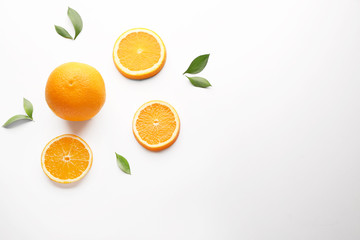 Fresh oranges with leaves on white background