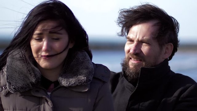 Closeup of man hugging crying girlfriend in exterior in winter slow motion
