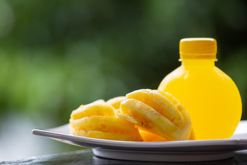 Pineapple that has flax deer in its side, flavored water bottle and has a green natural background.