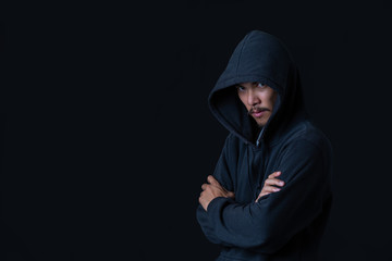 The concept of cyber theft. The hacker standing on her arms against the black background.