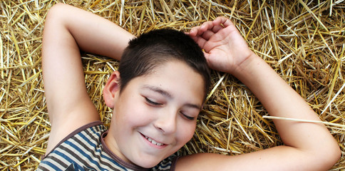 A young boy in a wheat field. Summer vacation