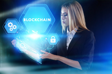 Business, Technology, Internet and network concept. Young businessman working on a virtual screen of the future and sees the inscription: Blockchain