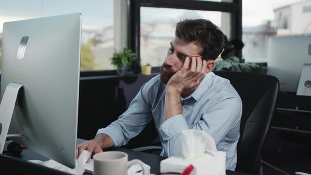 Bored or exhausted caucasian business employer falling asleep dreaming relaxing in chair at office table. Fun office people.