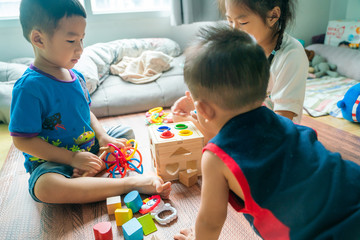 Obraz premium Group of baby playing in cozy room with toy