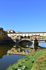 Ponte Vecchio and Arno River with blue sky. Florence, Italy.